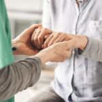 A professional healthcare manager conducting a comprehensive health and safety assessment for an elderly client at home.